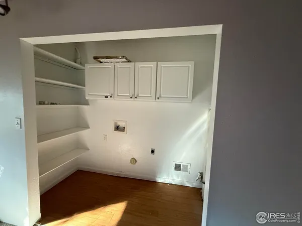 a view of walk in closet with empty racks