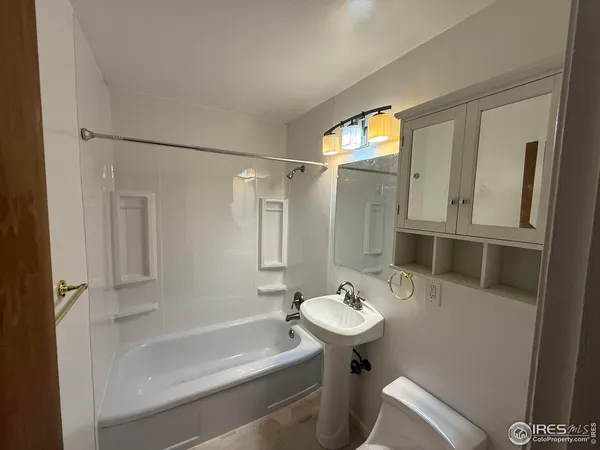 a bathroom with a sink a mirror and a bathtub