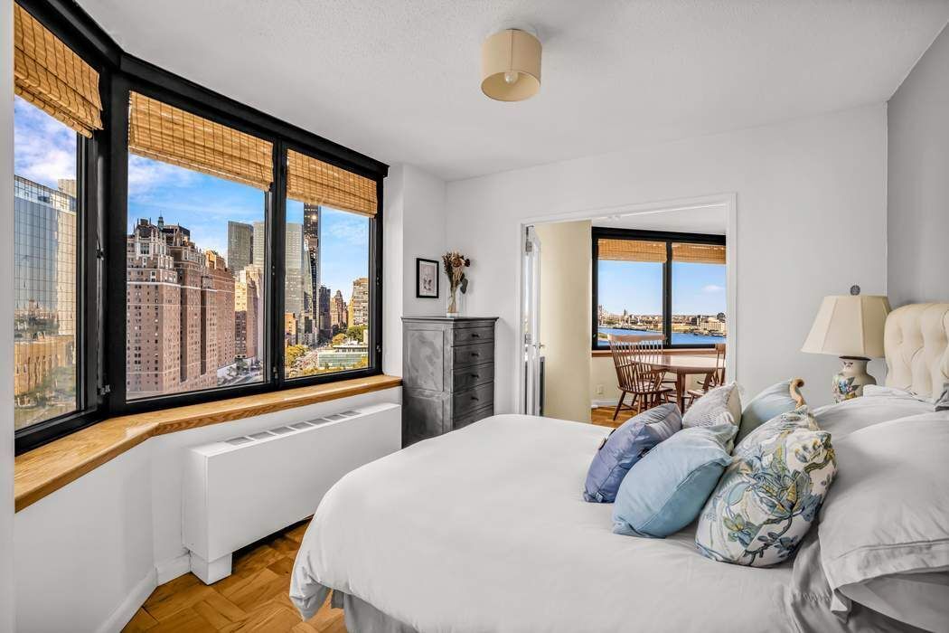 415 East 37th Street, Unit 21J Manhattan, NY 10016 - Photo 6 of 14 a bedroom with a large bed and a large window
