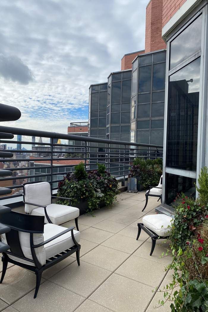 415 East 37th Street, Unit 21J Manhattan, NY 10016 - Photo 9 of 14 a building outdoor space with patio furniture and potted plants