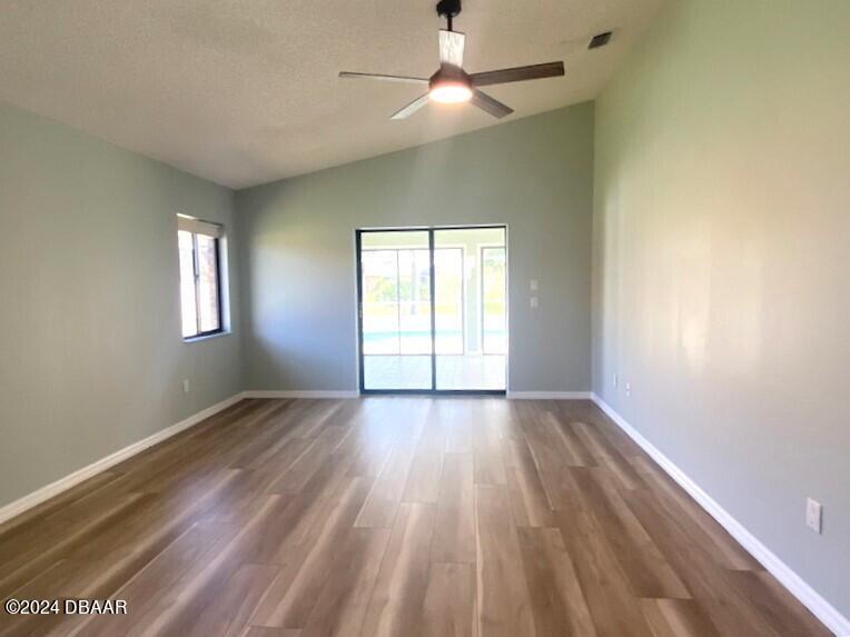 12 Julie Drive Ormond Beach, FL 32176 - Photo 11 of 24 wooden floor in an empty room with a window