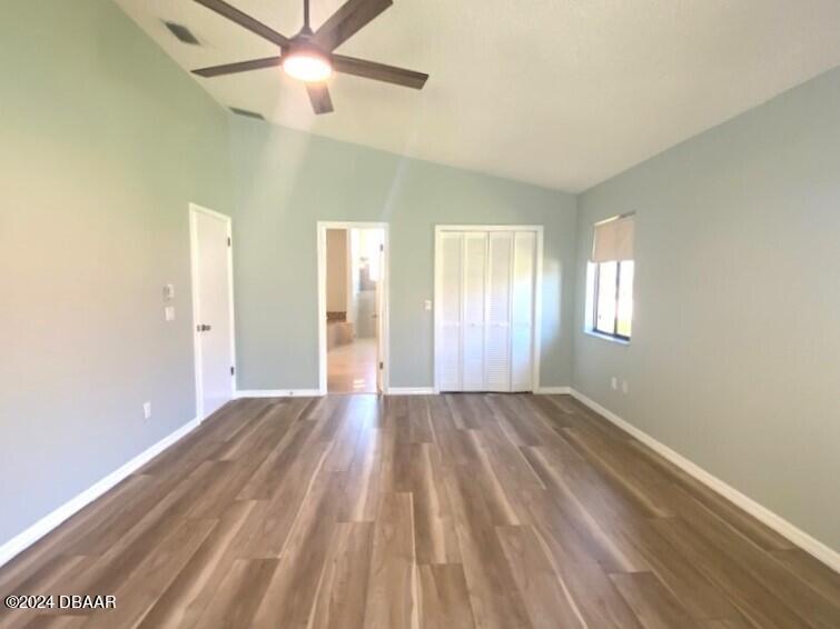 12 Julie Drive Ormond Beach, FL 32176 - Photo 12 of 24 a view of an empty room with window and wooden floor