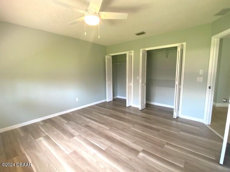 12 Julie Drive Ormond Beach, FL 32176 - Photo 15 of 24 a view of a livingroom with wooden floor and a ceiling fan