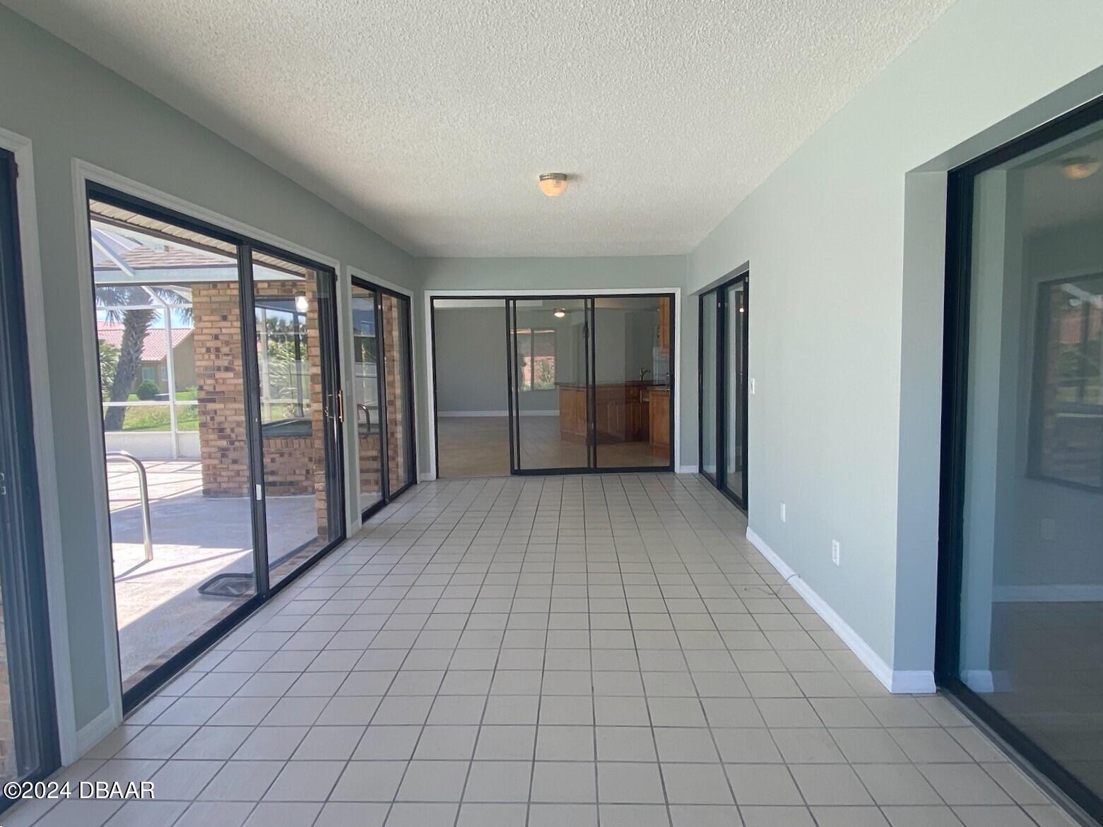 12 Julie Drive Ormond Beach, FL 32176 - Photo 21 of 24 a view of empty room with floor to ceiling window and an entryway