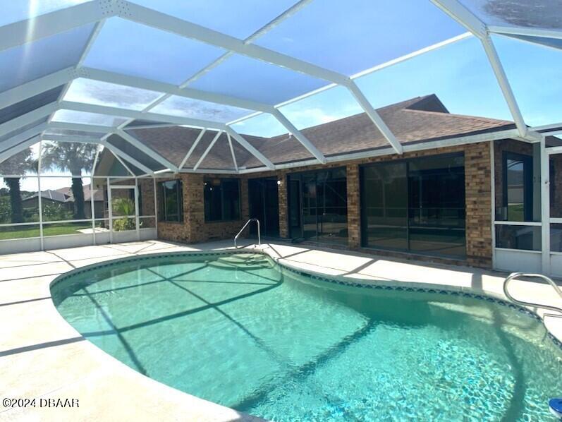 12 Julie Drive Ormond Beach, FL 32176 - Photo 23 of 24 a view of a house with a backyard and porch