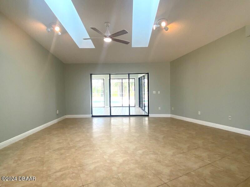 12 Julie Drive Ormond Beach, FL 32176 - Photo 3 of 24 an empty room with chandelier fan and windows