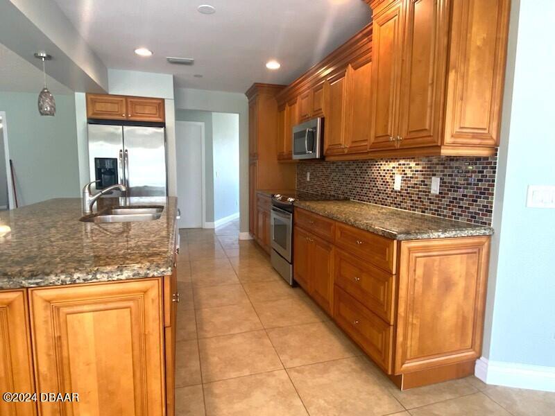 12 Julie Drive Ormond Beach, FL 32176 - Photo 7 of 24 a kitchen with stainless steel appliances granite countertop wooden cabinets a sink and dishwasher