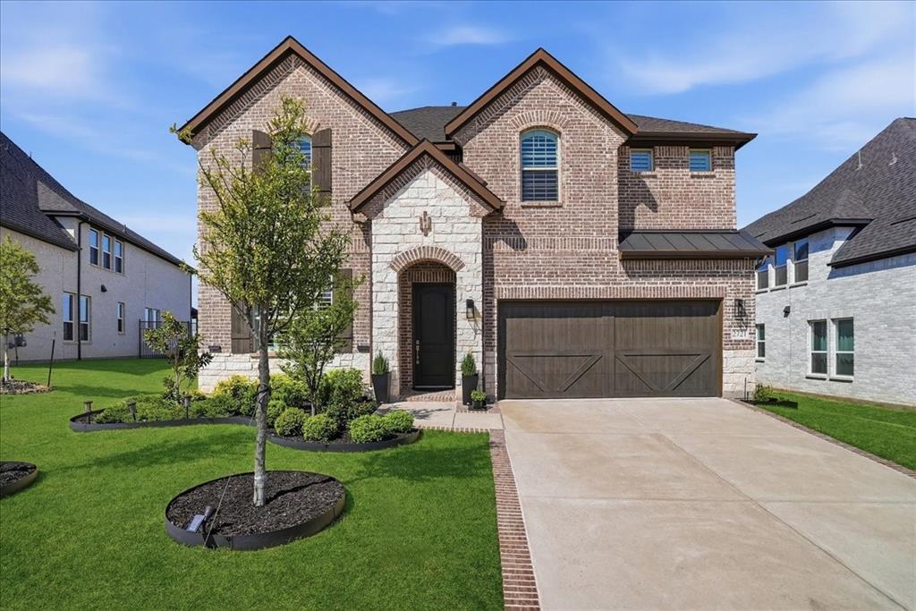2721 Rotherham Street Prosper, TX 75078 - Photo 33 of 37 a front view of a house with a yard and garage