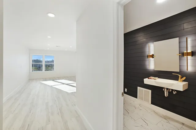 a bedroom with furniture and large windows