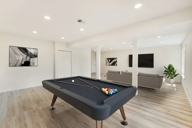 a view of staircase with wooden floor and fan