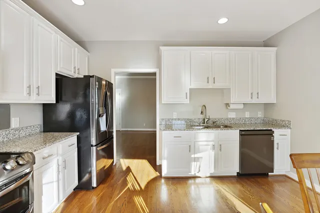 a bedroom with bed and a potted plant
