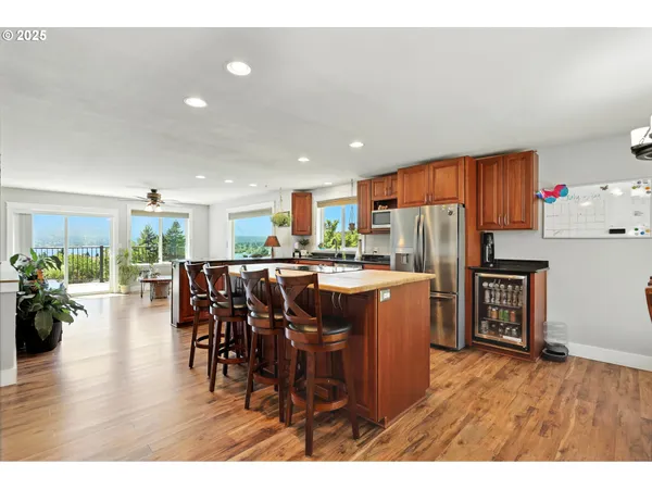 a living room with stainless steel appliances kitchen island granite countertop furniture a dining table and chairs