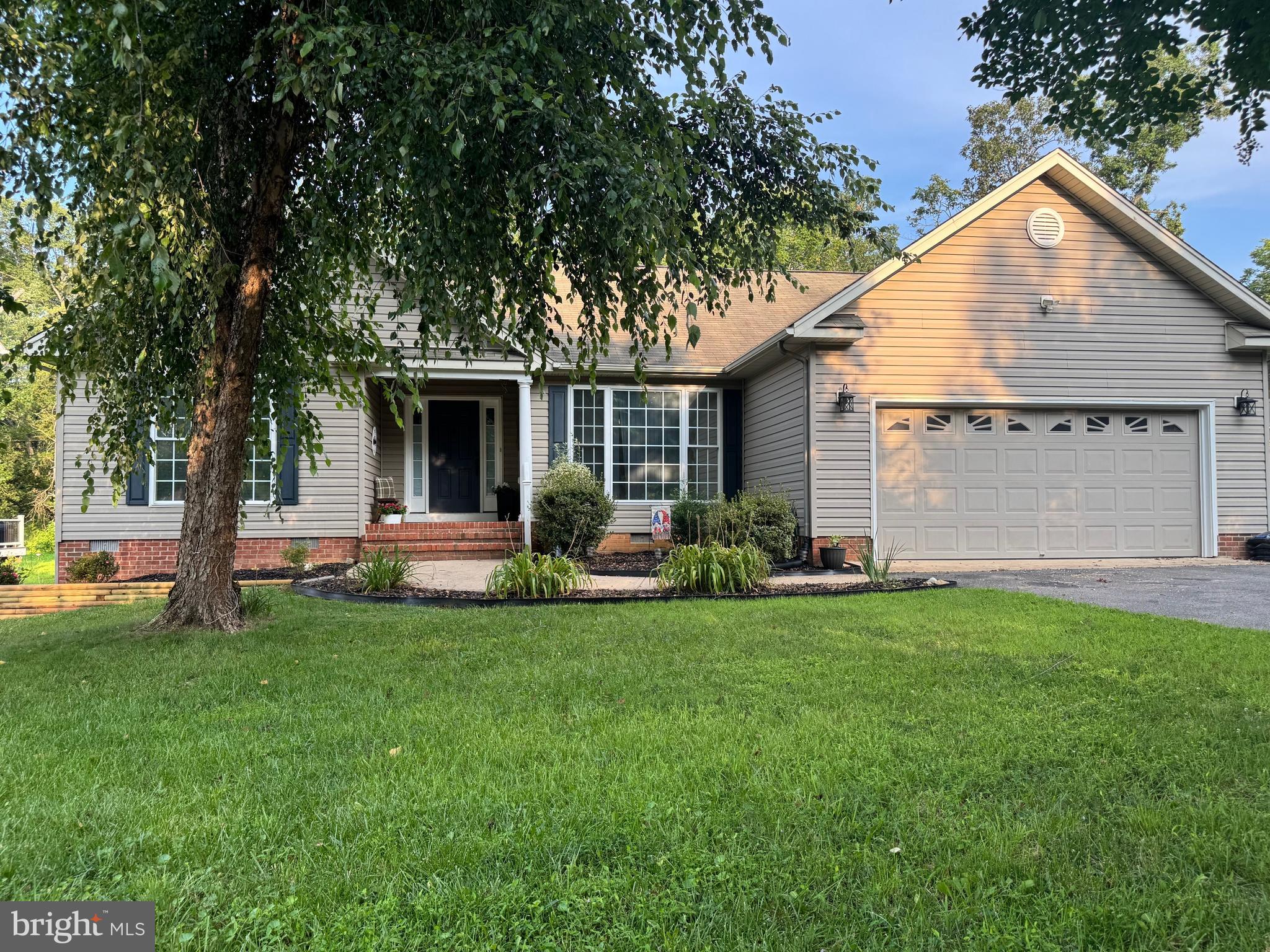 a view of a house with a yard and sitting area
