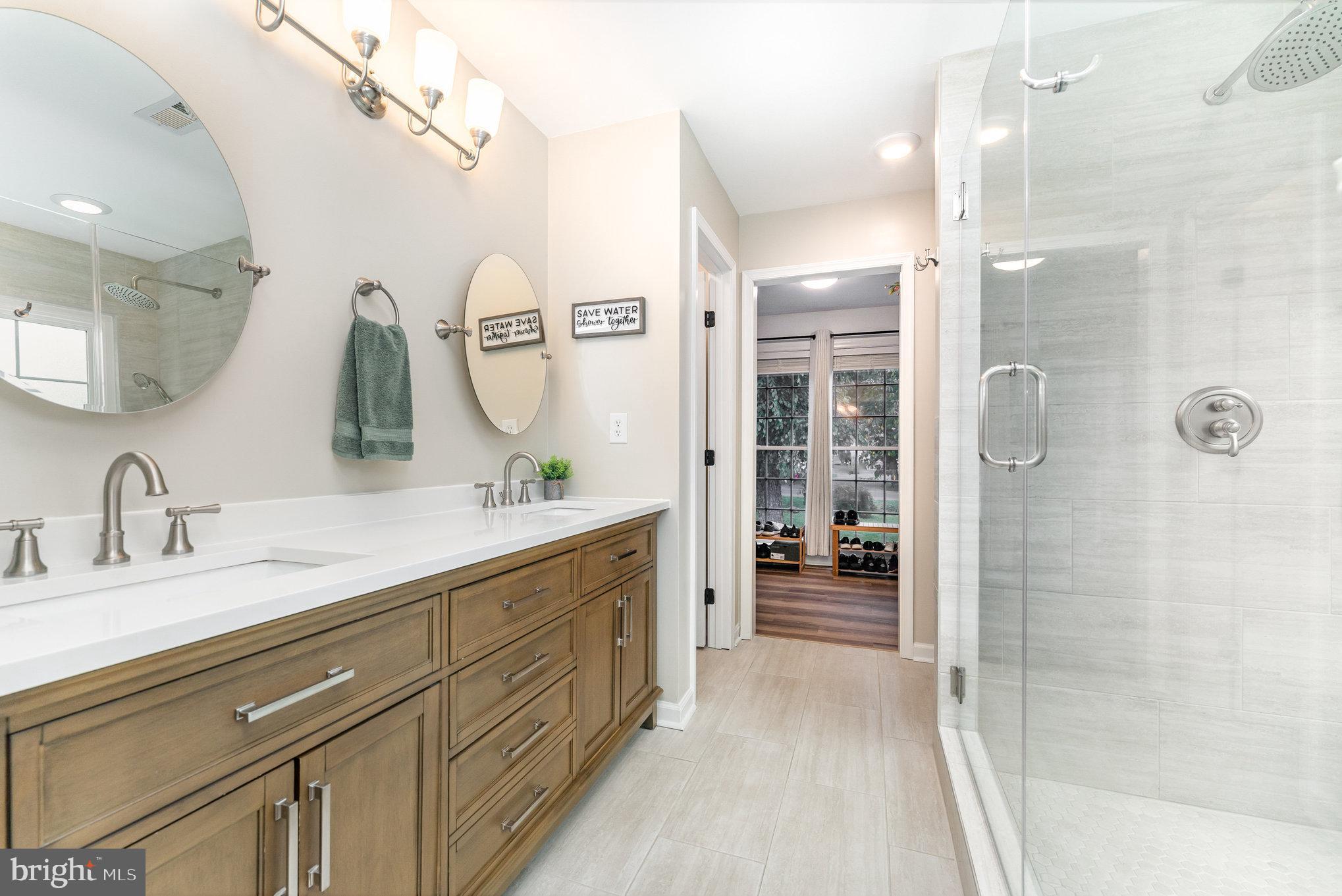 102 Parliament Street Locust Grove, VA 22508 - Photo 17 of 29 a bathroom with a double vanity sink mirror and shower
