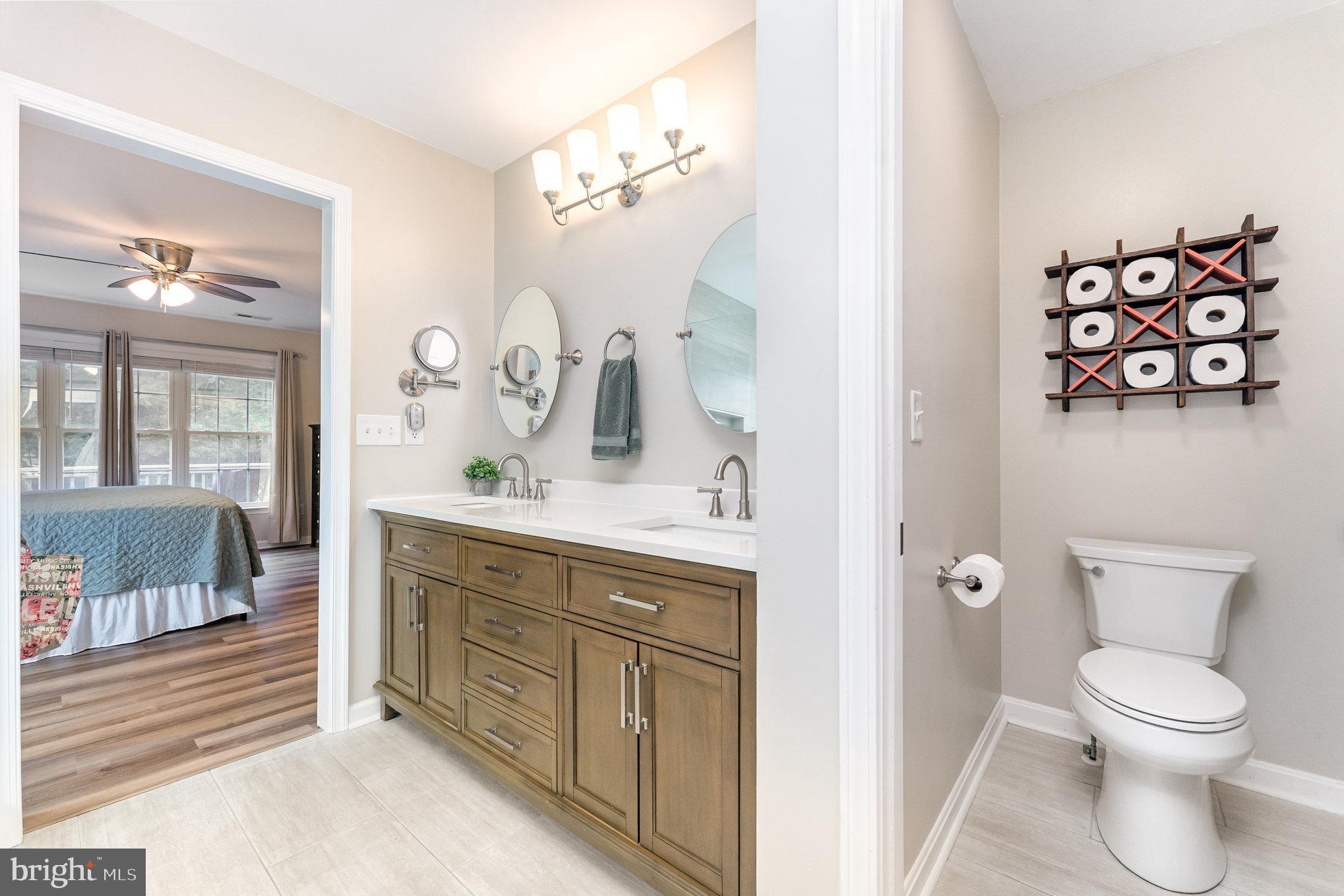 102 Parliament Street Locust Grove, VA 22508 - Photo 18 of 29 a bathroom with a toilet a sink and mirror