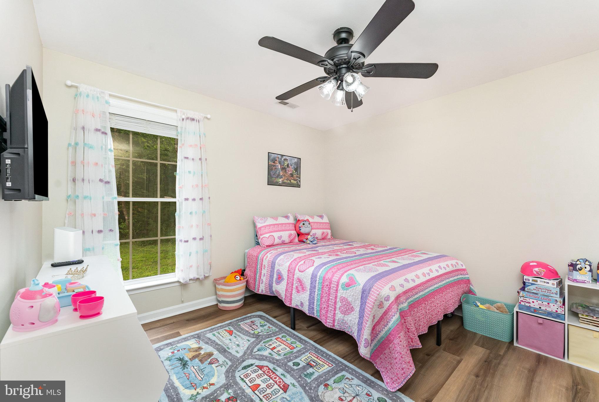 102 Parliament Street Locust Grove, VA 22508 - Photo 20 of 29 a bedroom with a bed and wooden floor