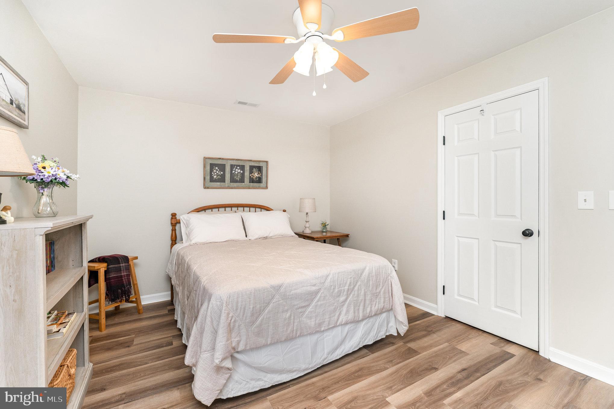 102 Parliament Street Locust Grove, VA 22508 - Photo 21 of 29 a bedroom with a bed and a chandelier