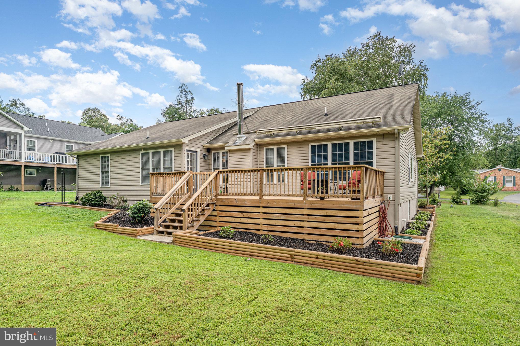 102 Parliament Street Locust Grove, VA 22508 - Photo 25 of 29 a view of a house with a yard porch and sitting area