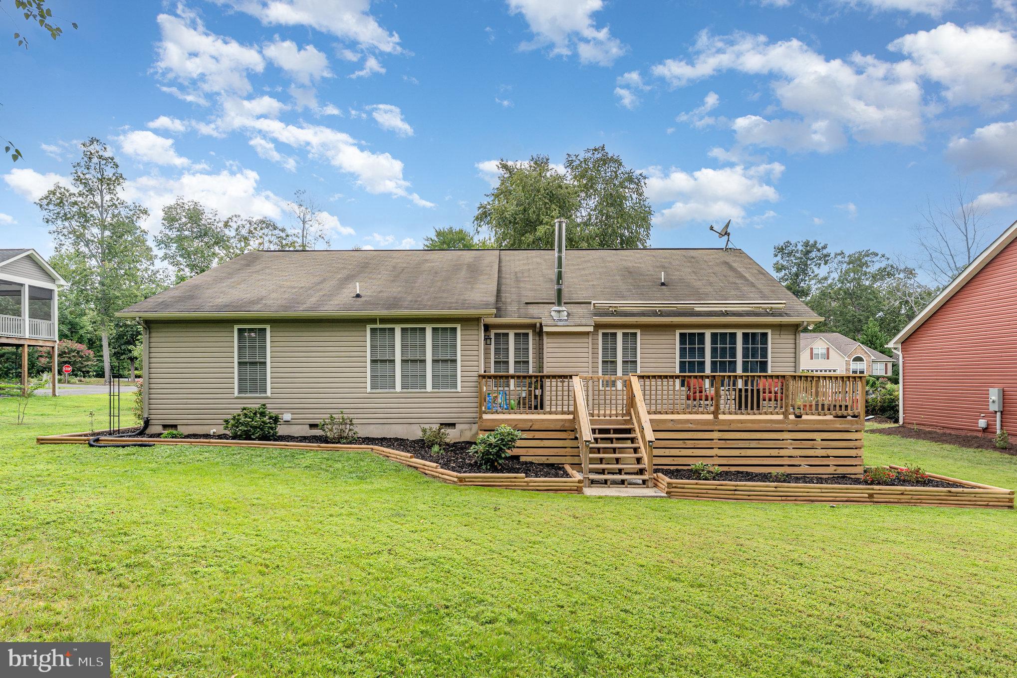 102 Parliament Street Locust Grove, VA 22508 - Photo 26 of 29 a view of a house with backyard sitting area and garden