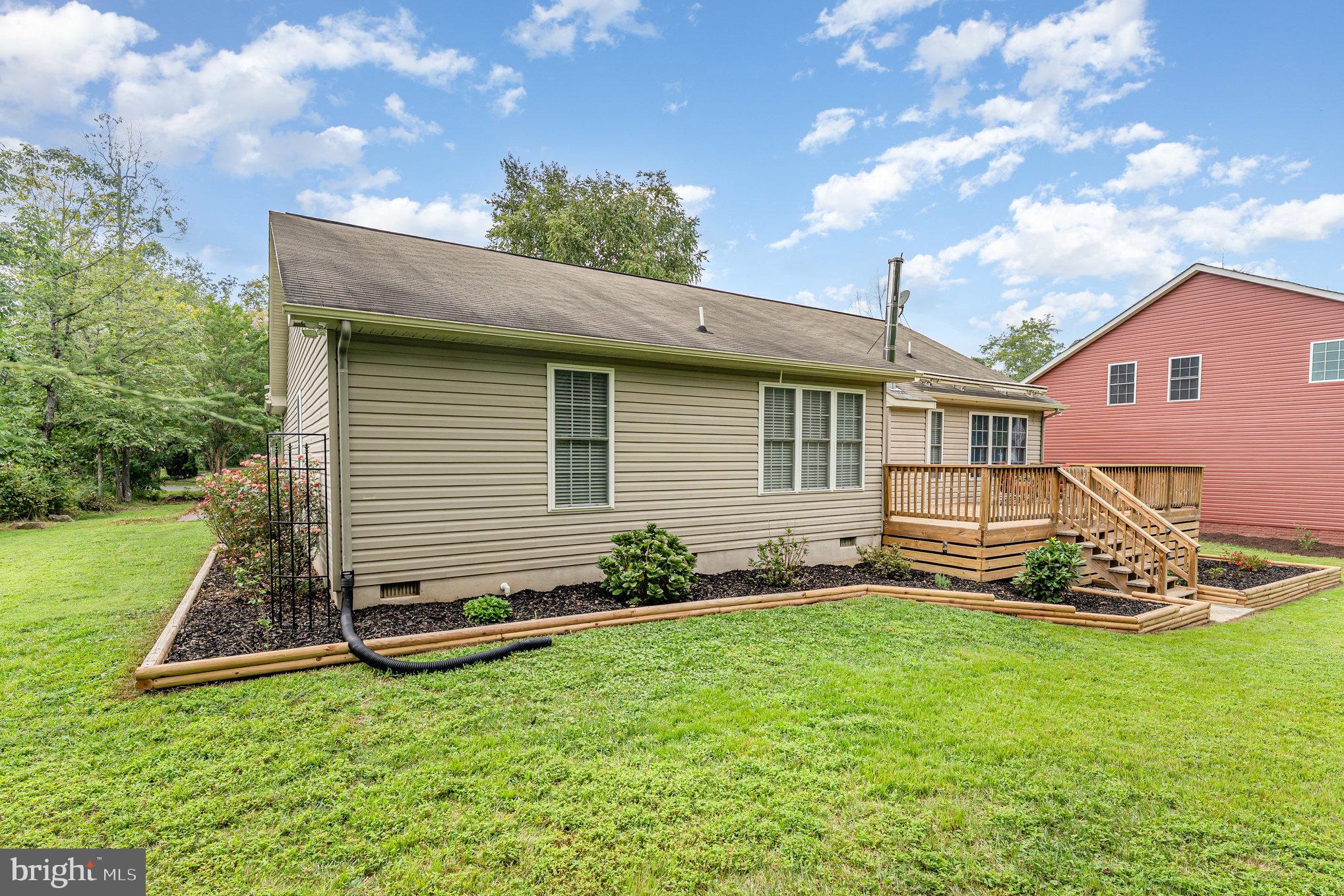 102 Parliament Street Locust Grove, VA 22508 - Photo 27 of 29 a front view of a house with garden