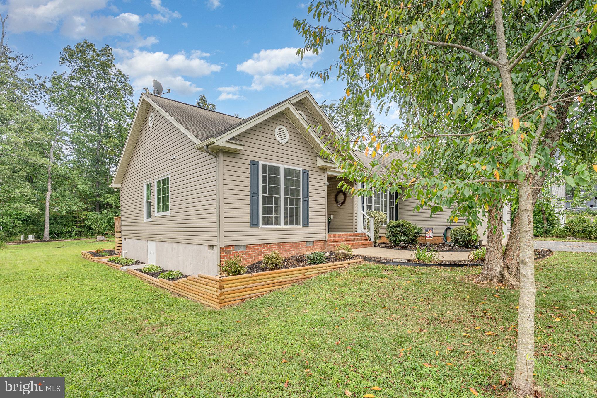 102 Parliament Street Locust Grove, VA 22508 - Photo 28 of 29 a view of a house with a yard and sitting area