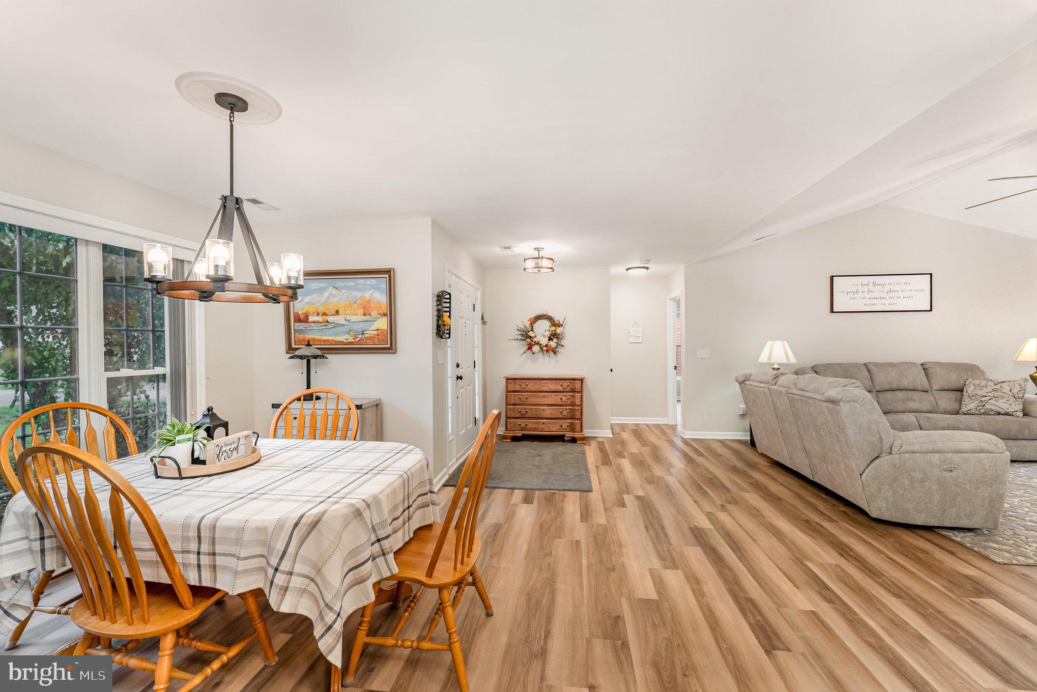 102 Parliament Street Locust Grove, VA 22508 - Photo 9 of 29 a spacious bedroom with a bed and a chandelier