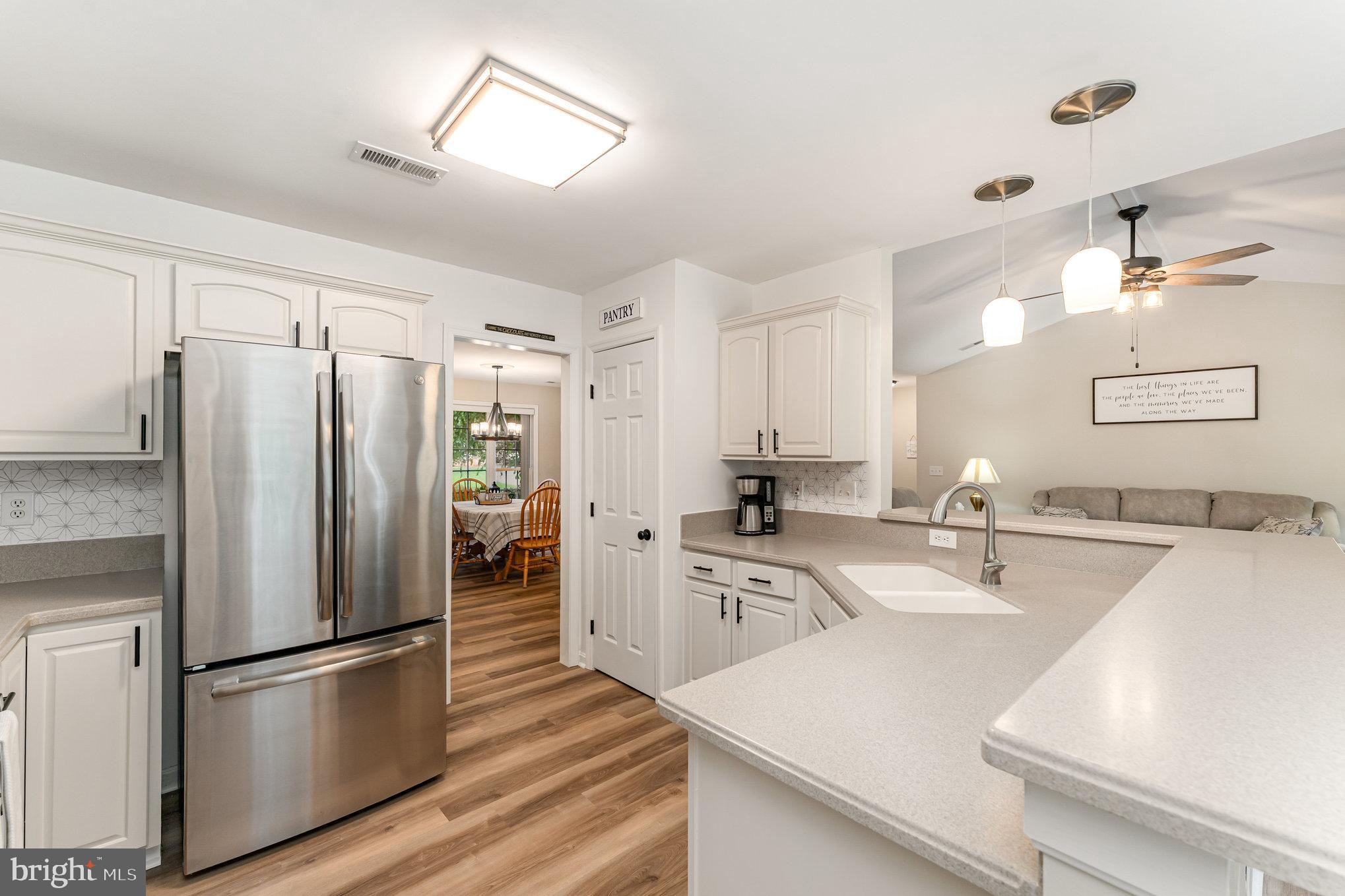 102 Parliament Street Locust Grove, VA 22508 - Photo 10 of 29 a kitchen with a refrigerator a sink and cabinets