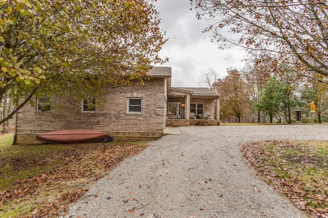 a living room with couches a flat screen tv and chairs