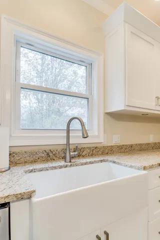 a spacious bedroom with a bed and large windows