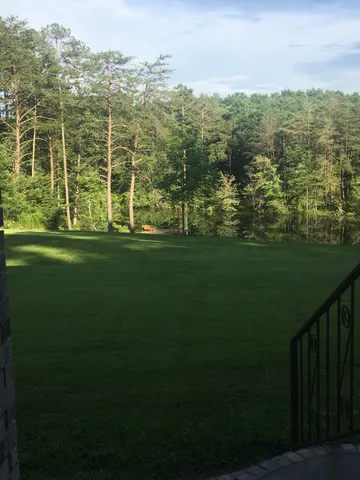 a kitchen with stainless steel appliances granite countertop a sink refrigerator and cabinets