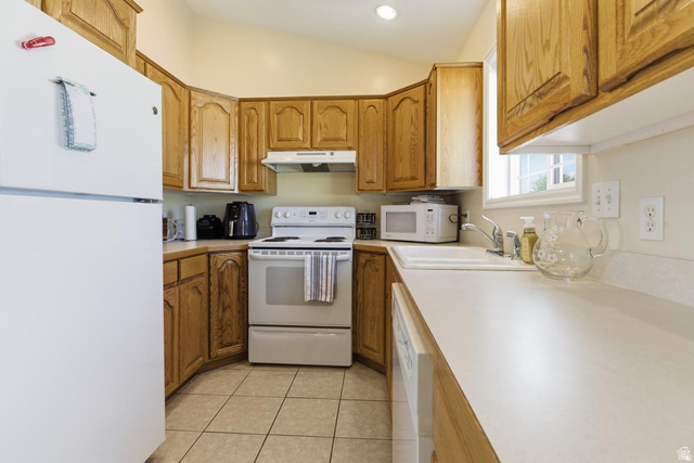 619 East 1st S Street, Unit S Preston, ID 83263 - Photo 8 of 16 Kitchen featuring light wood cabinetry, white appliances, durable countertops, a double basin sink, and tile flooring