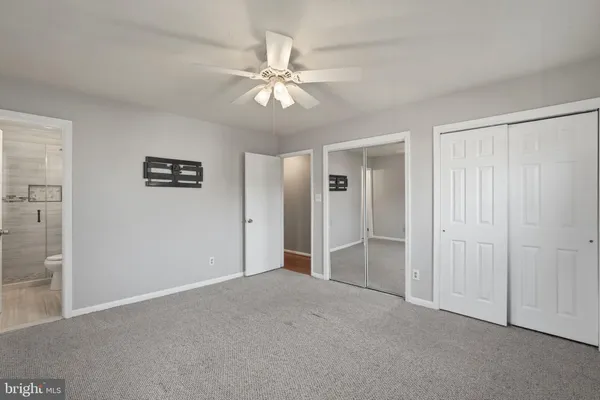 a view of an empty room with a fan
