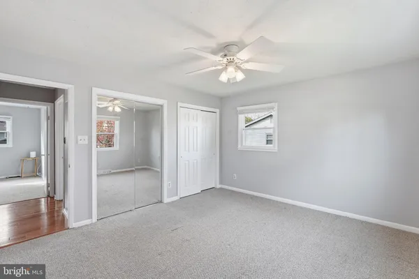 an empty room with fan and entrance