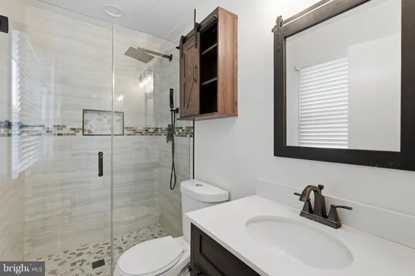 a bathroom with a sink toilet and shower