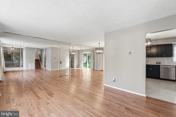 a view of a kitchen with wooden floor and a sink