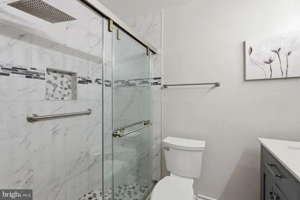 a white toilet sitting next to a bathroom sink