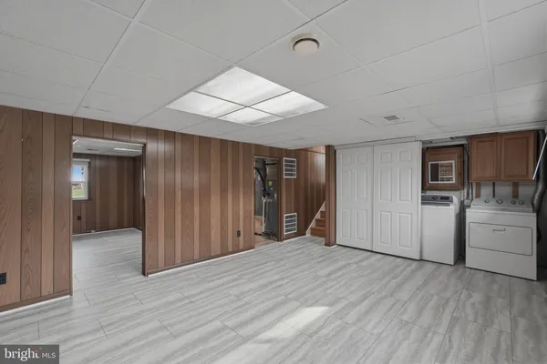 an empty room with wooden floor and cabinet