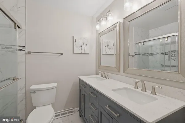 a bathroom with a sink toilet vanity and shower