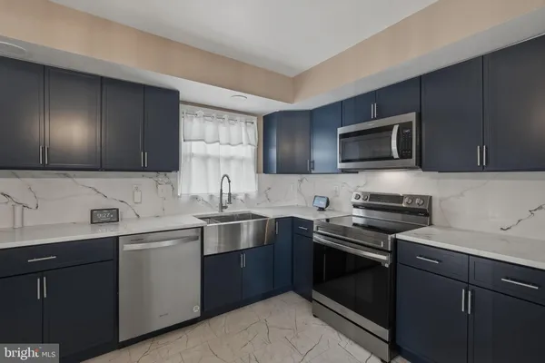 a kitchen with a sink stove and microwave