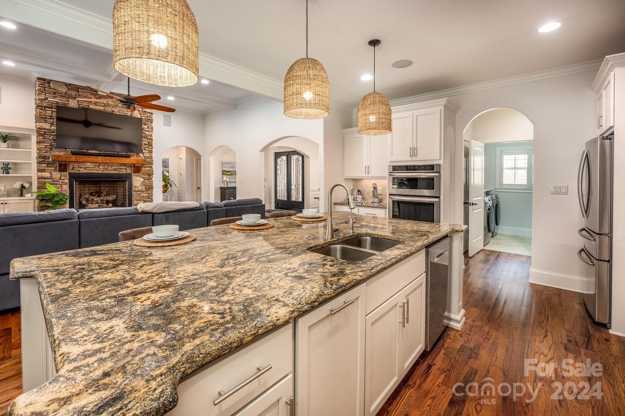 320 Barber Loop Mooresville, NC 28117 - Photo 13 of 44 a large kitchen with stainless steel appliances granite countertop a stove and cabinets
