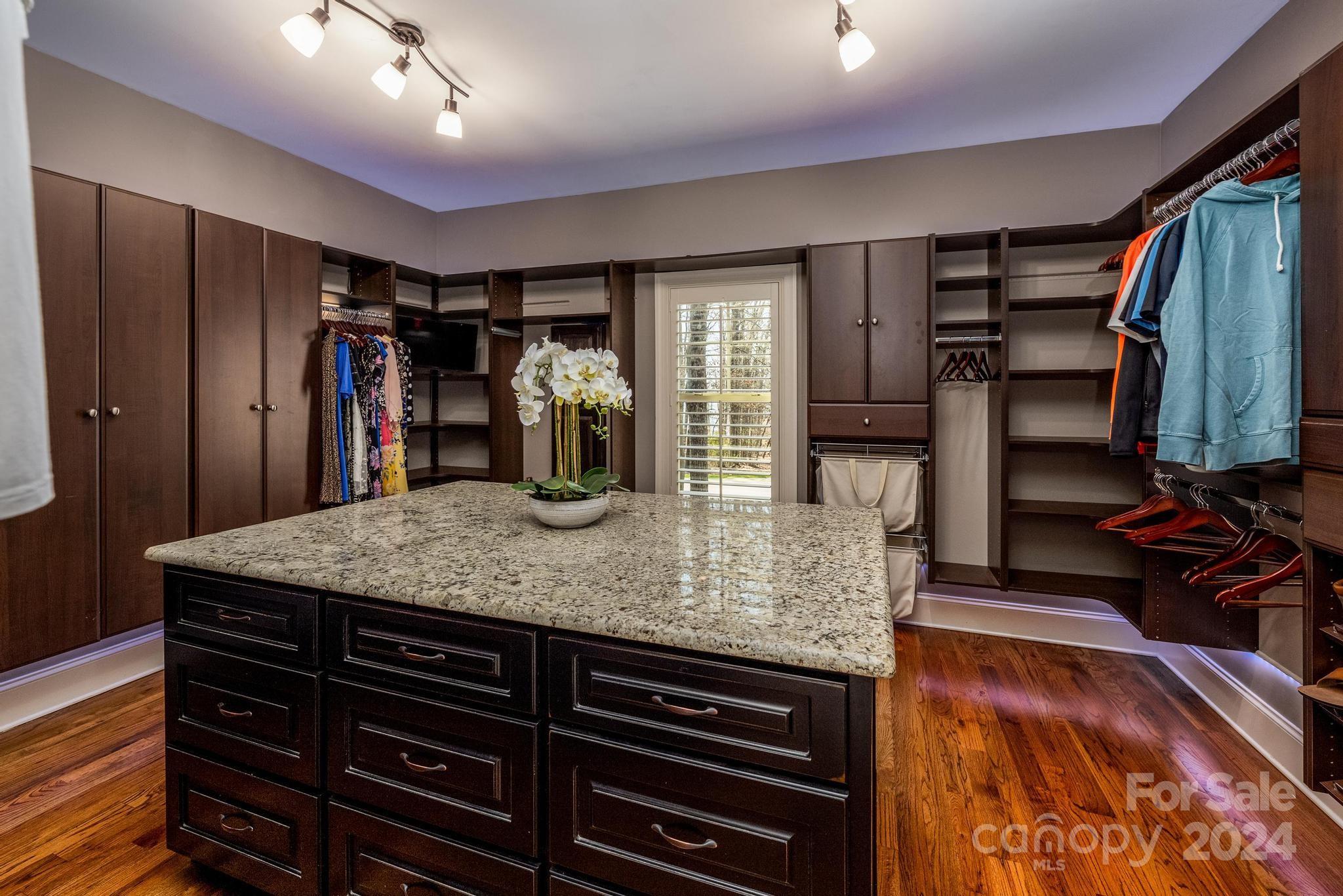 320 Barber Loop Mooresville, NC 28117 - Photo 19 of 44 a kitchen with stainless steel appliances granite countertop a sink counter space cabinets and wooden floor