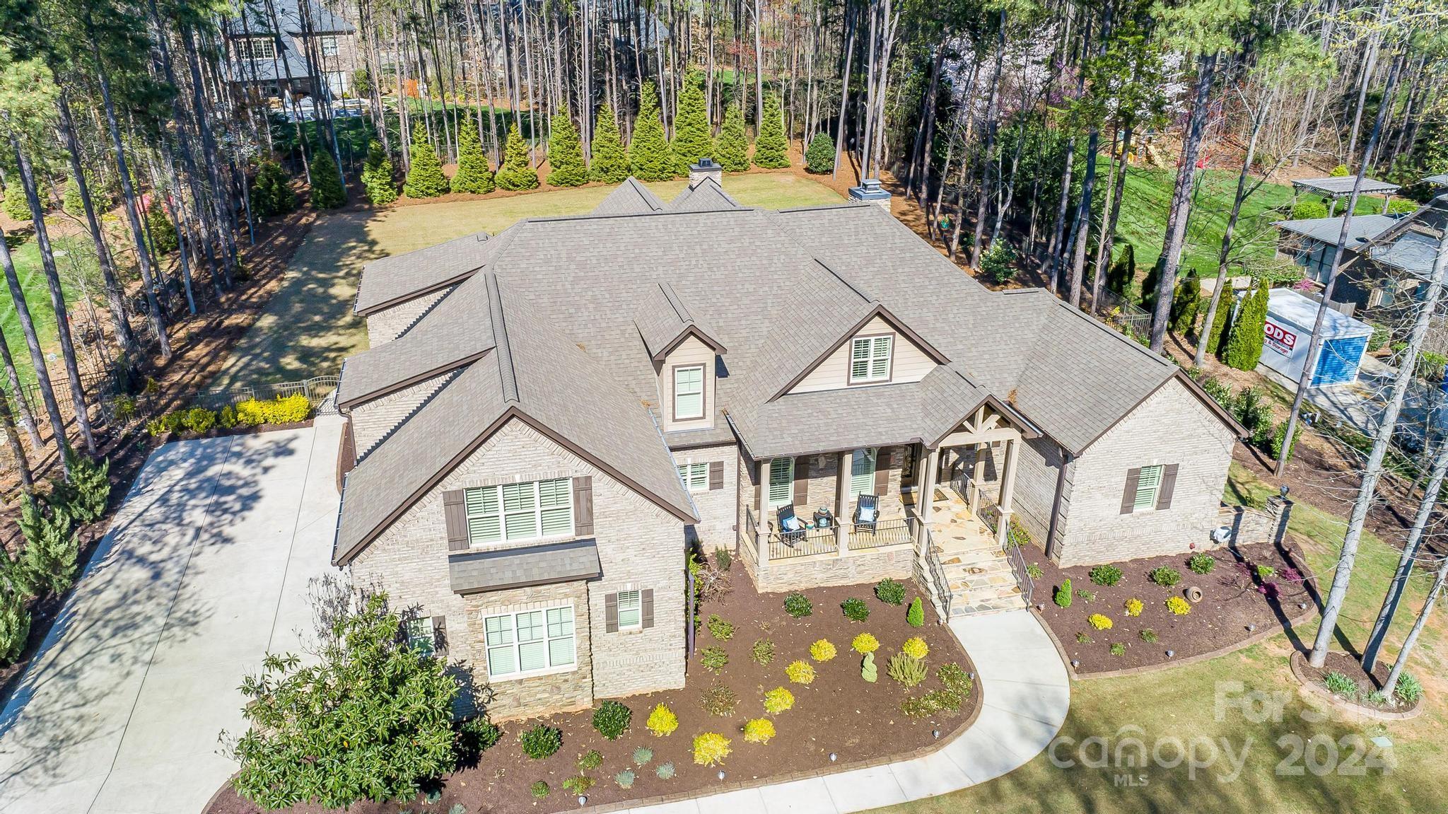 320 Barber Loop Mooresville, NC 28117 - Photo 3 of 44 a view of a white house with a swimming pool and lawn chairs under an umbrella