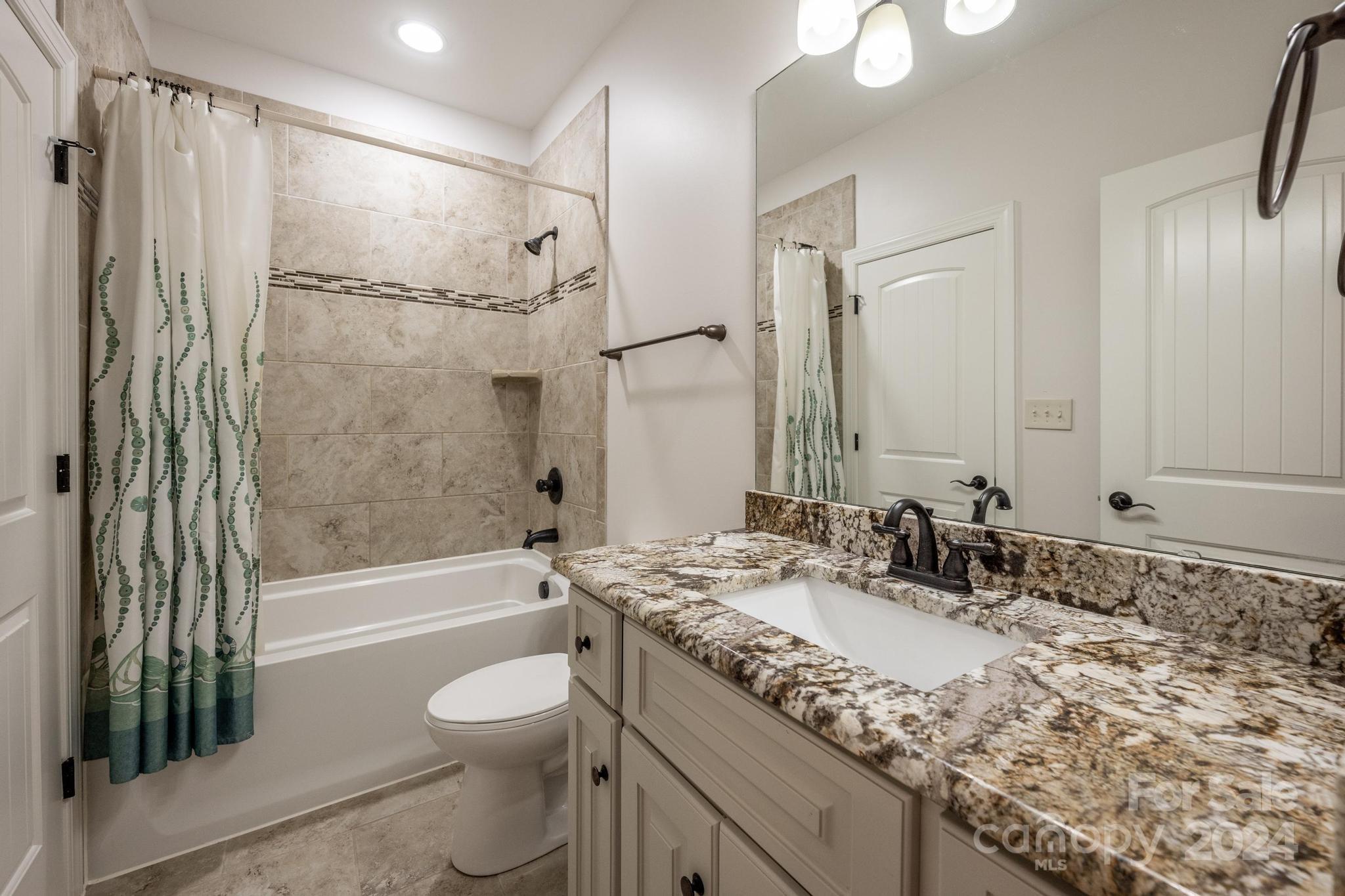 320 Barber Loop Mooresville, NC 28117 - Photo 31 of 44 a bathroom with a granite countertop sink toilet and shower