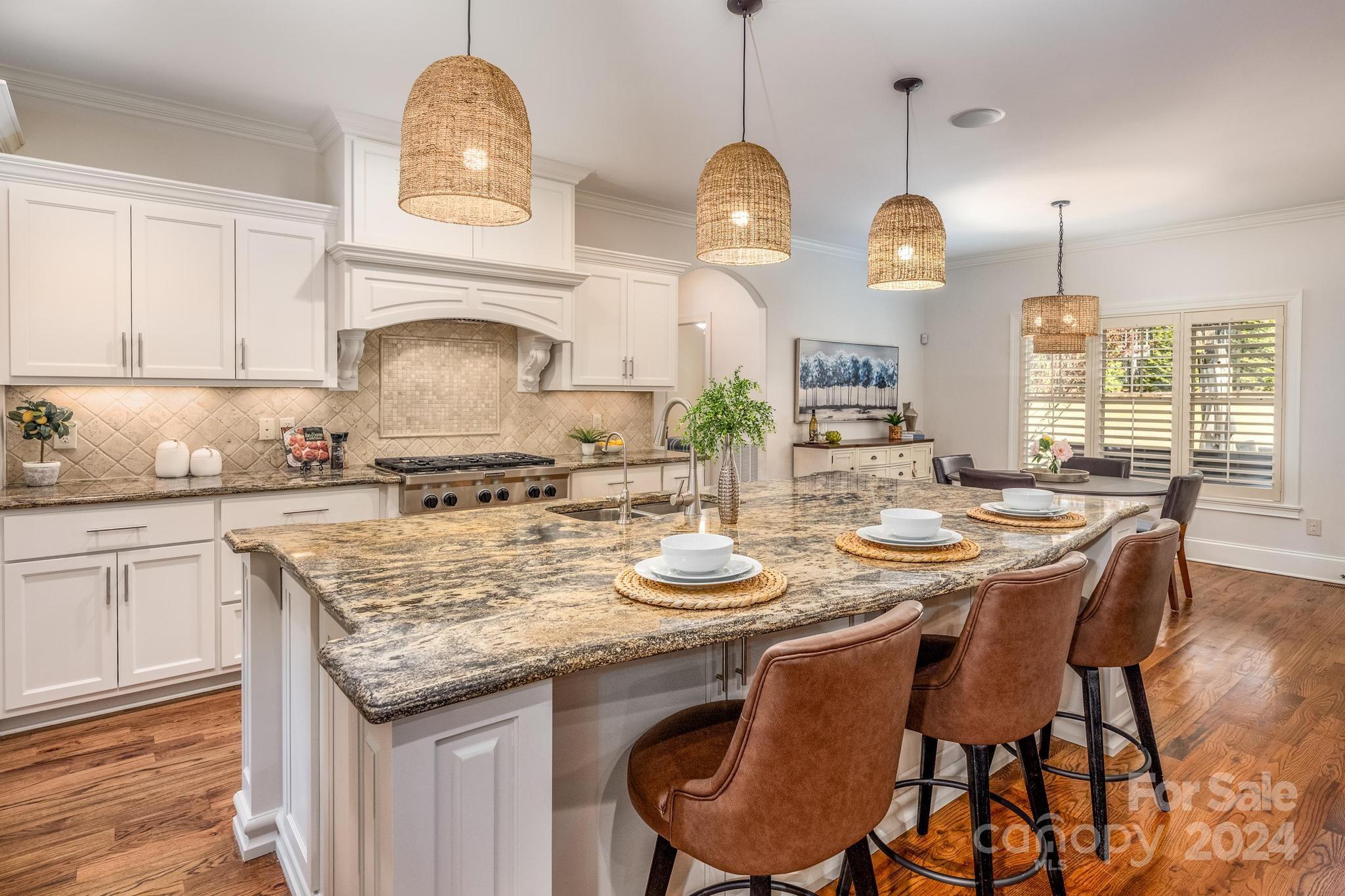 320 Barber Loop Mooresville, NC 28117 - Photo 10 of 44 a kitchen with granite countertop kitchen island a table and a sink