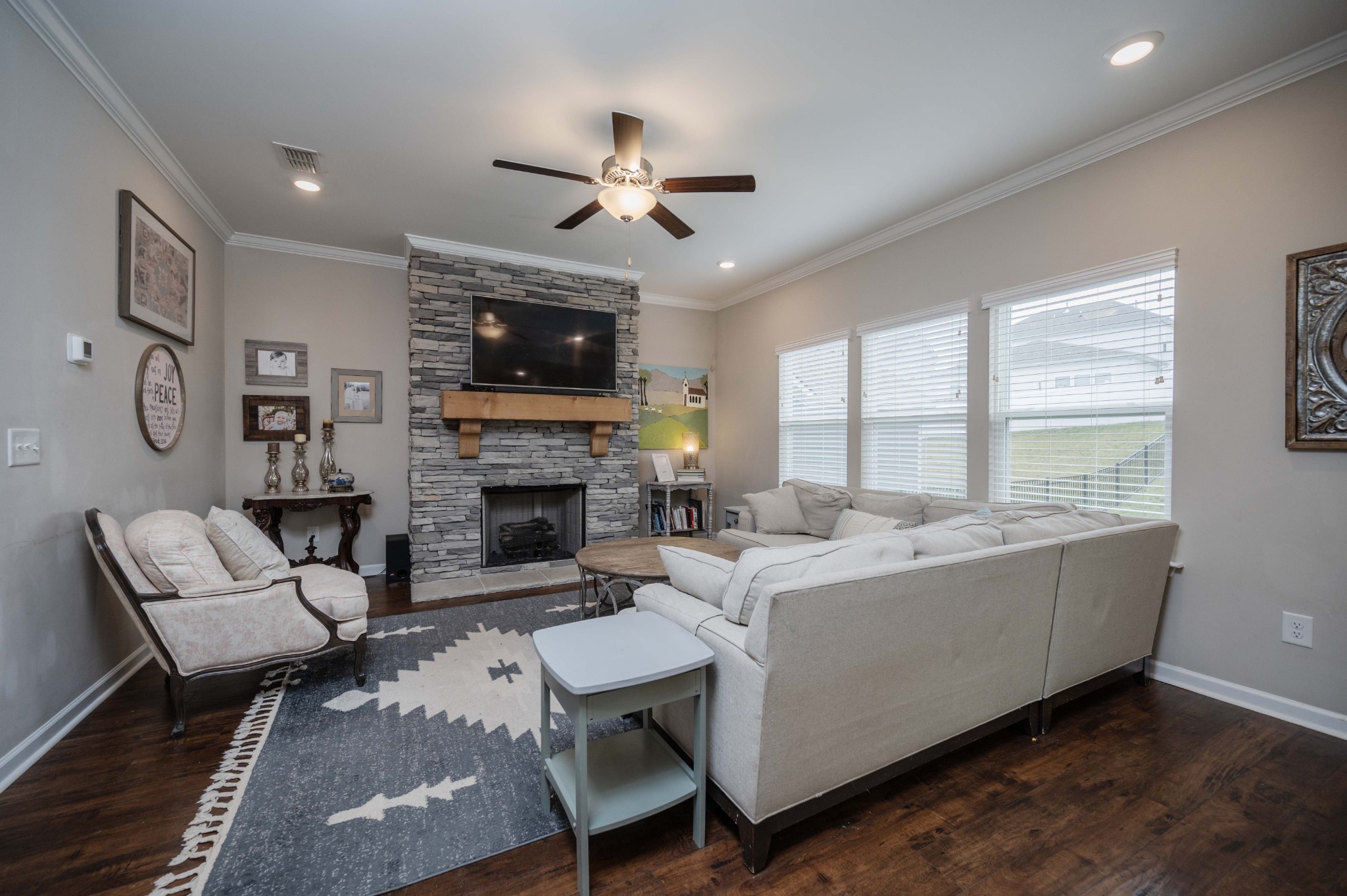 416 Butler Road Mount Juliet, TN 37122 - Photo 9 of 46 a living room with furniture a flat screen tv and a fireplace
