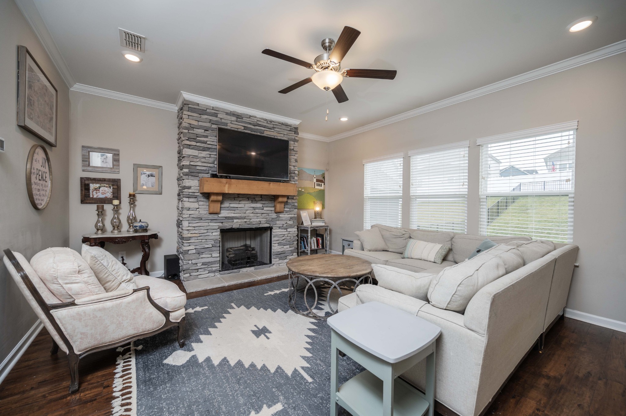 416 Butler Road Mount Juliet, TN 37122 - Photo 10 of 46 a living room with furniture a fireplace and a flat screen tv