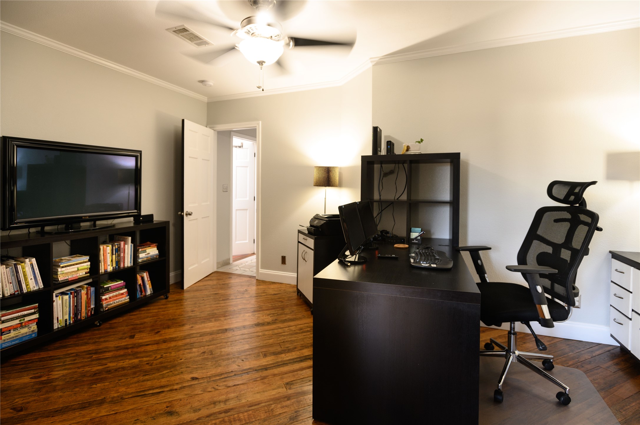 4902 Pecan Springs Road Austin, TX 78723 - Photo 28 of 40 a view of a workspace with furniture and a flat screen tv
