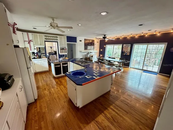 a living room with furniture a flat screen tv and wooden floor