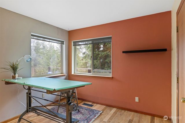 a workspace room with furniture and wooden floor