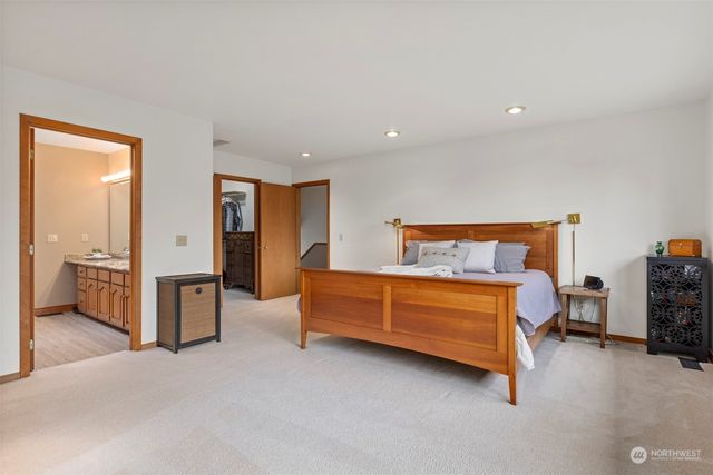 a bedroom with furniture and a flat tv screen